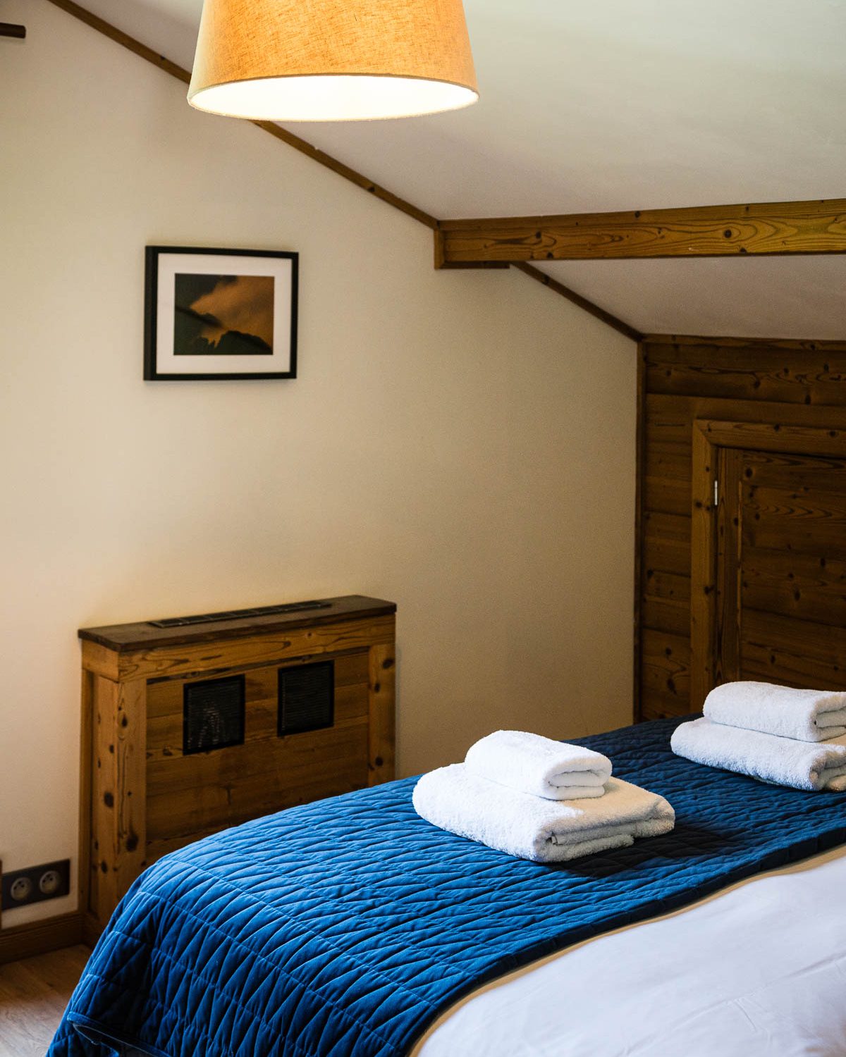 Double bedroom with blue bedding at Chalet Coffy in Morzine