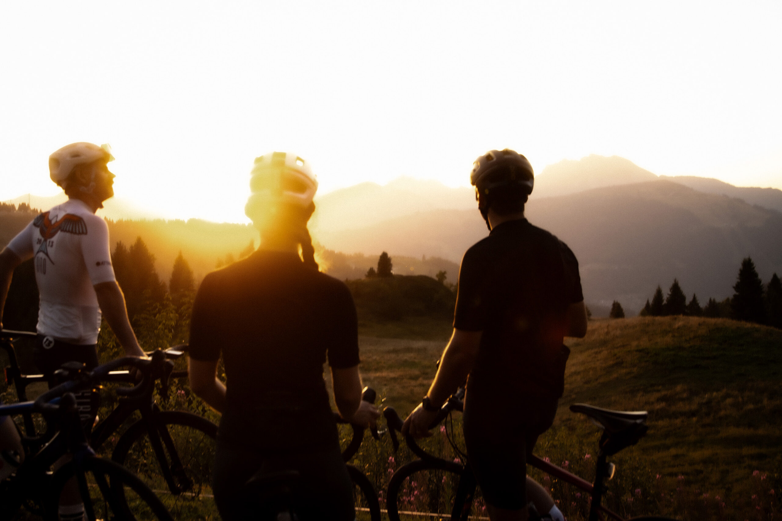 Road cyclists in the Morzine mountains at sunset
