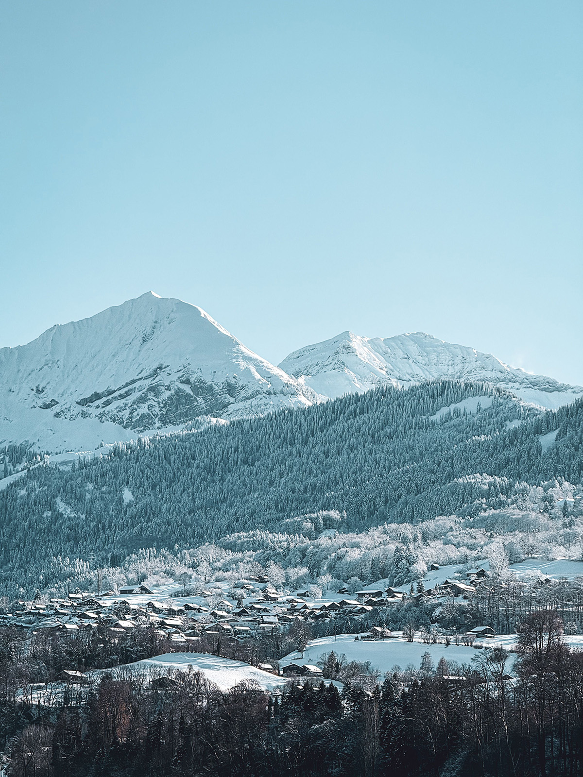 Morzine village beneath snow-covered mountains in winter