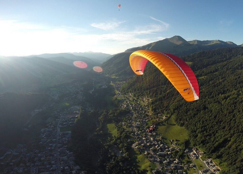 Paraglider flying above the mountains near Morzine