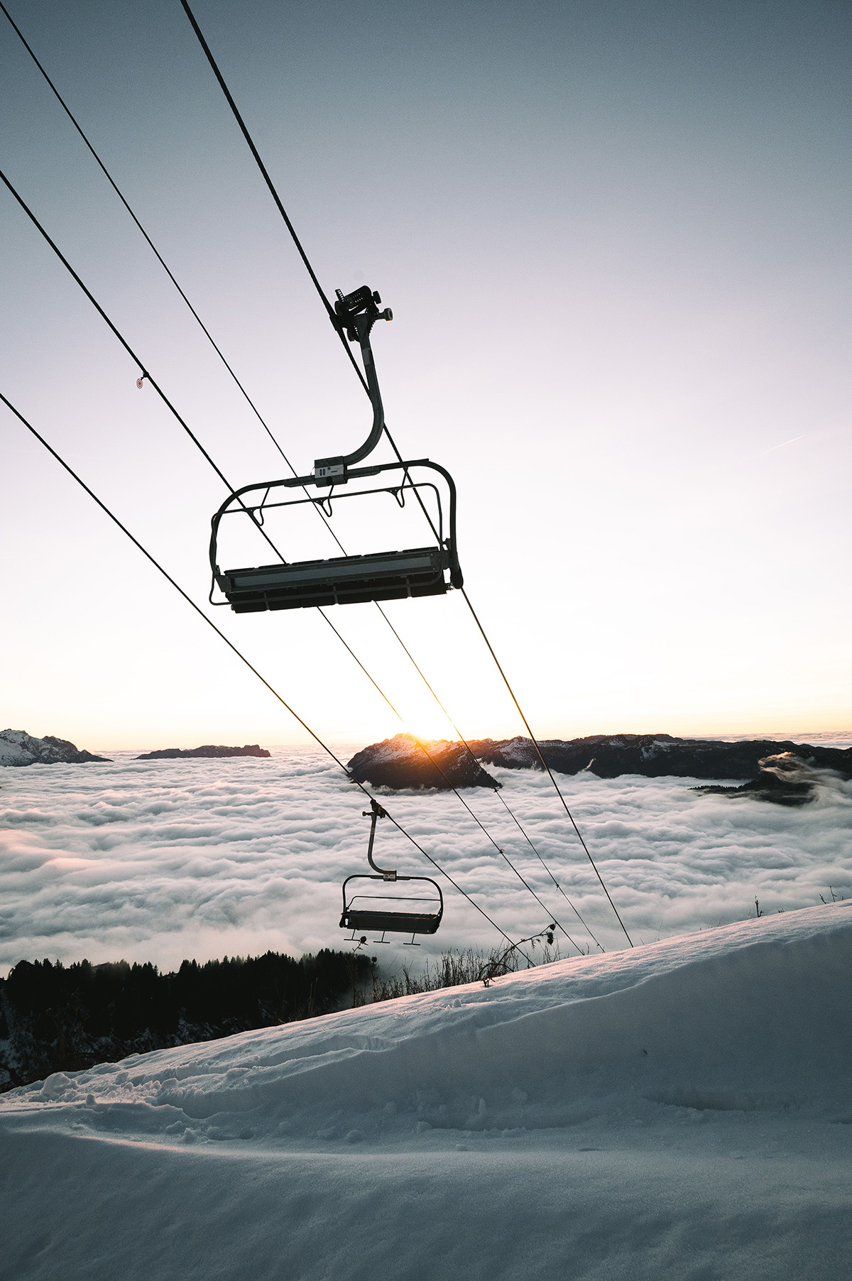 Chairlift travelling over snowy ski slopes