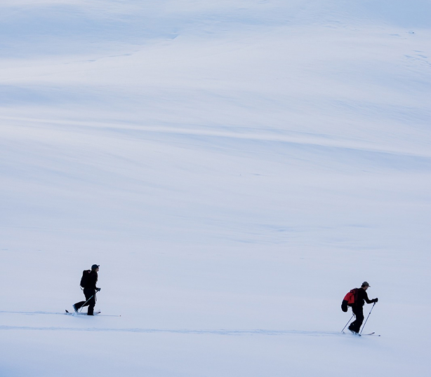 Ski tourers crossing a snowy mountain slope in Morzine