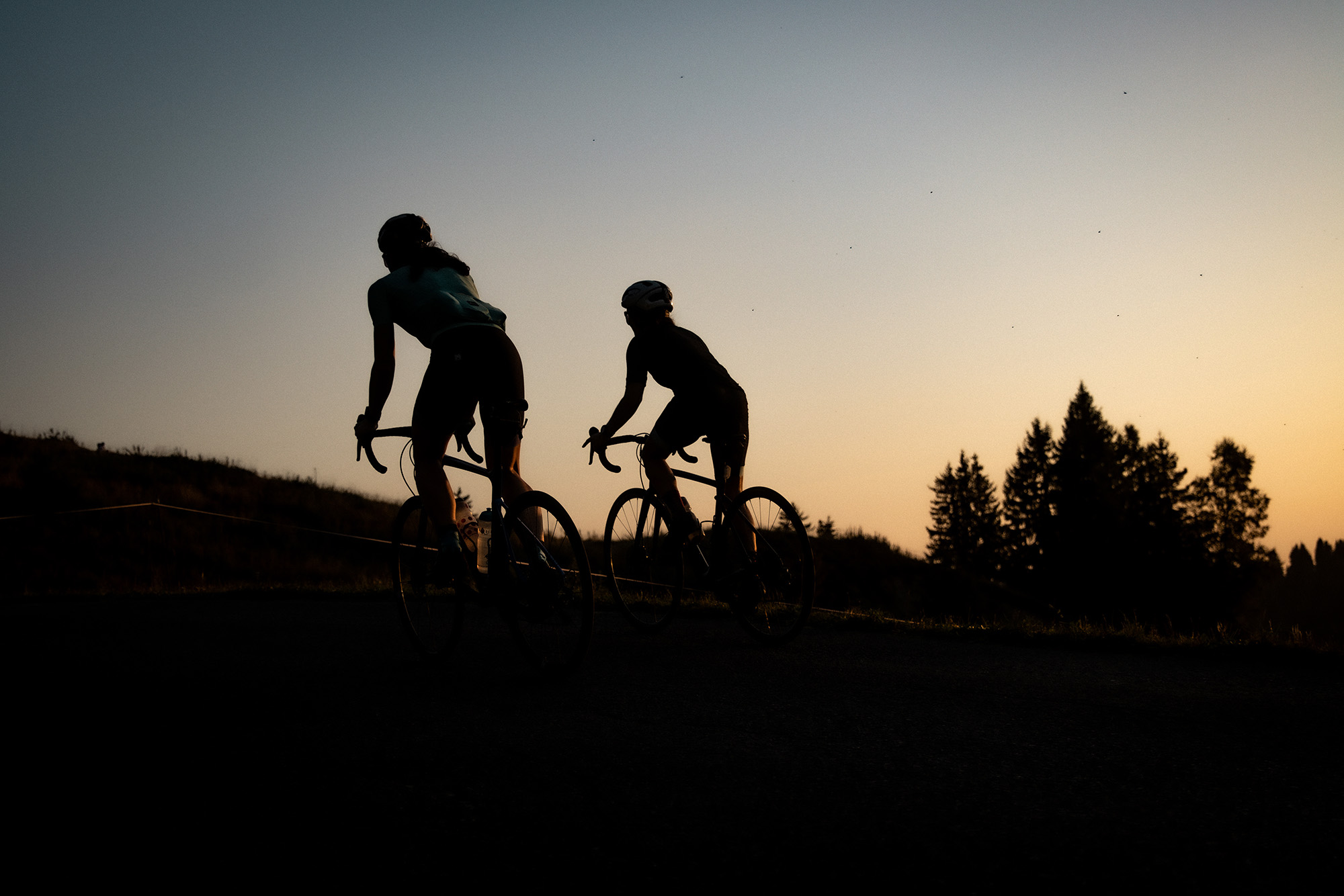 Road cyclists riding at sunset near Morzine