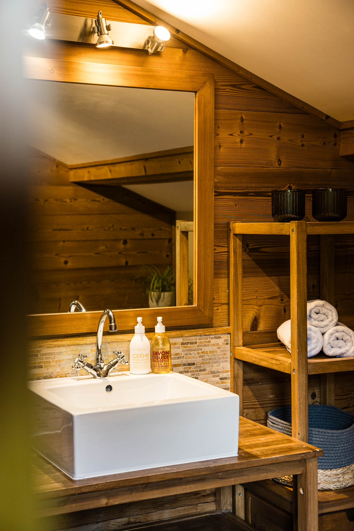 Bathroom vanity with wooden furnishings, fresh towels and alpine timber walls at Chalet Coffy