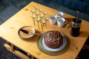 Homemade chocolate cake with coffee and mugs ready to serve at Chalet Coffy