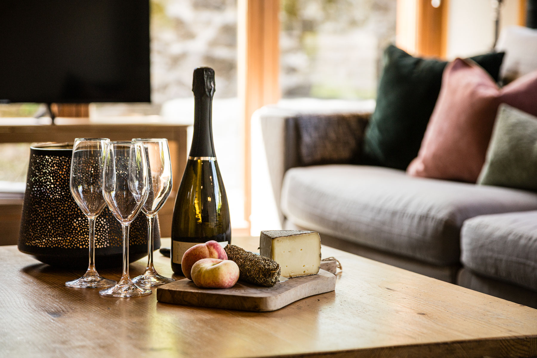 Wine, glasses and local food arranged in the cosy lounge at Chalet Coffy