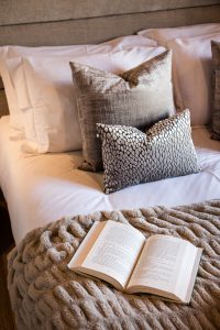 Open book and soft furnishings in a Chalet Floralies bedroom