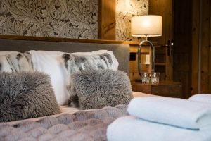 Soft furnishings and prepared bed at Chalet Floralies