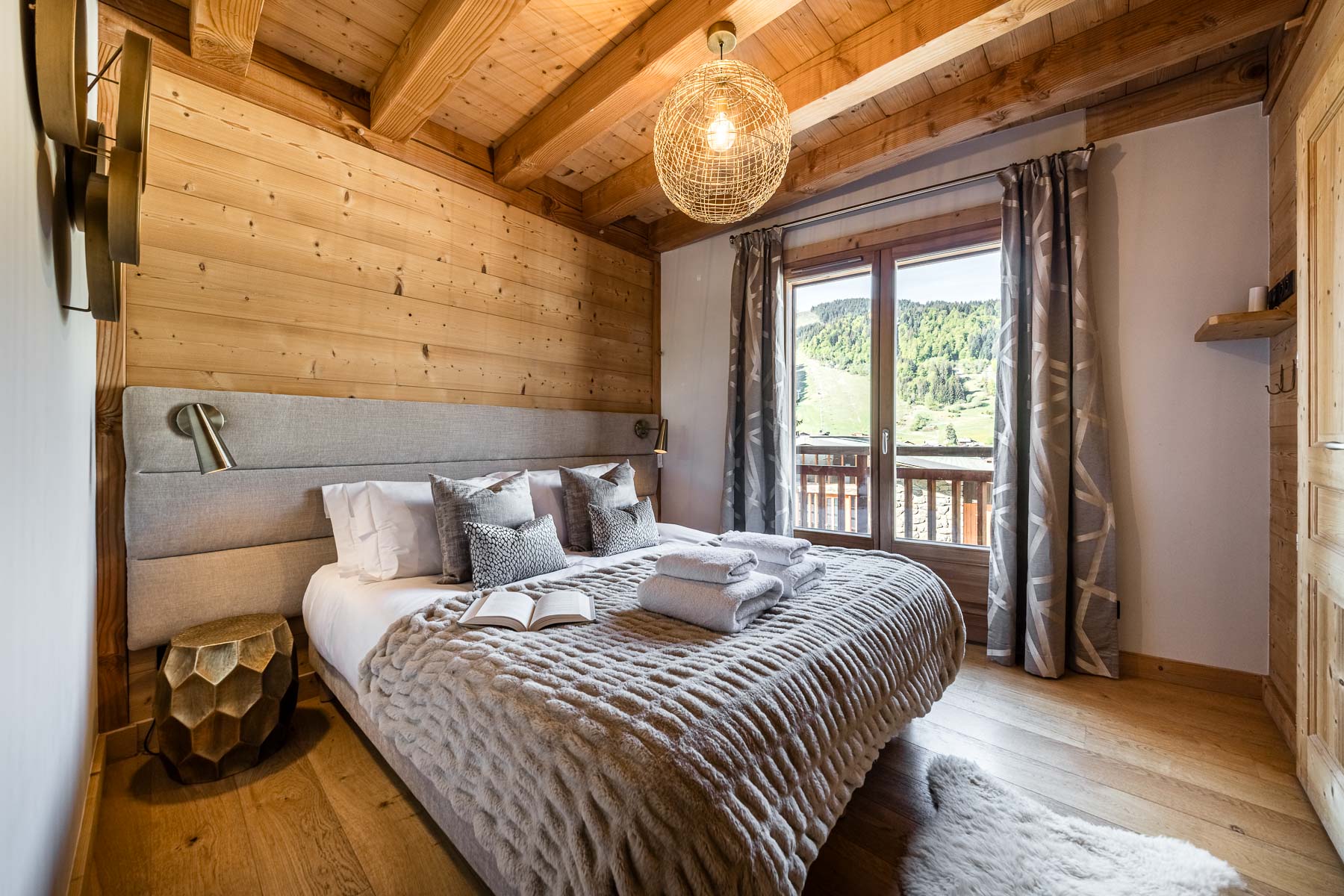 Double bedroom with balcony views at Chalet Floralies