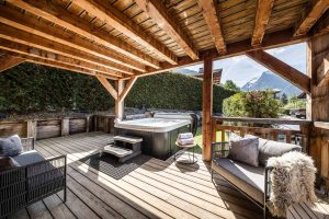 Terrace hot tub with mountain views at Chalet Floralies