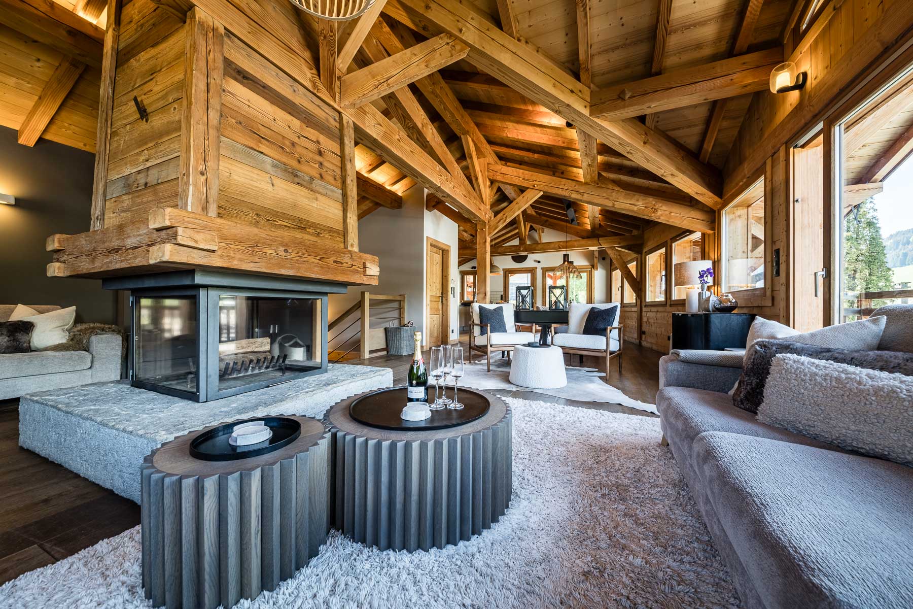 Seating around the central fireplace at Chalet Floralies