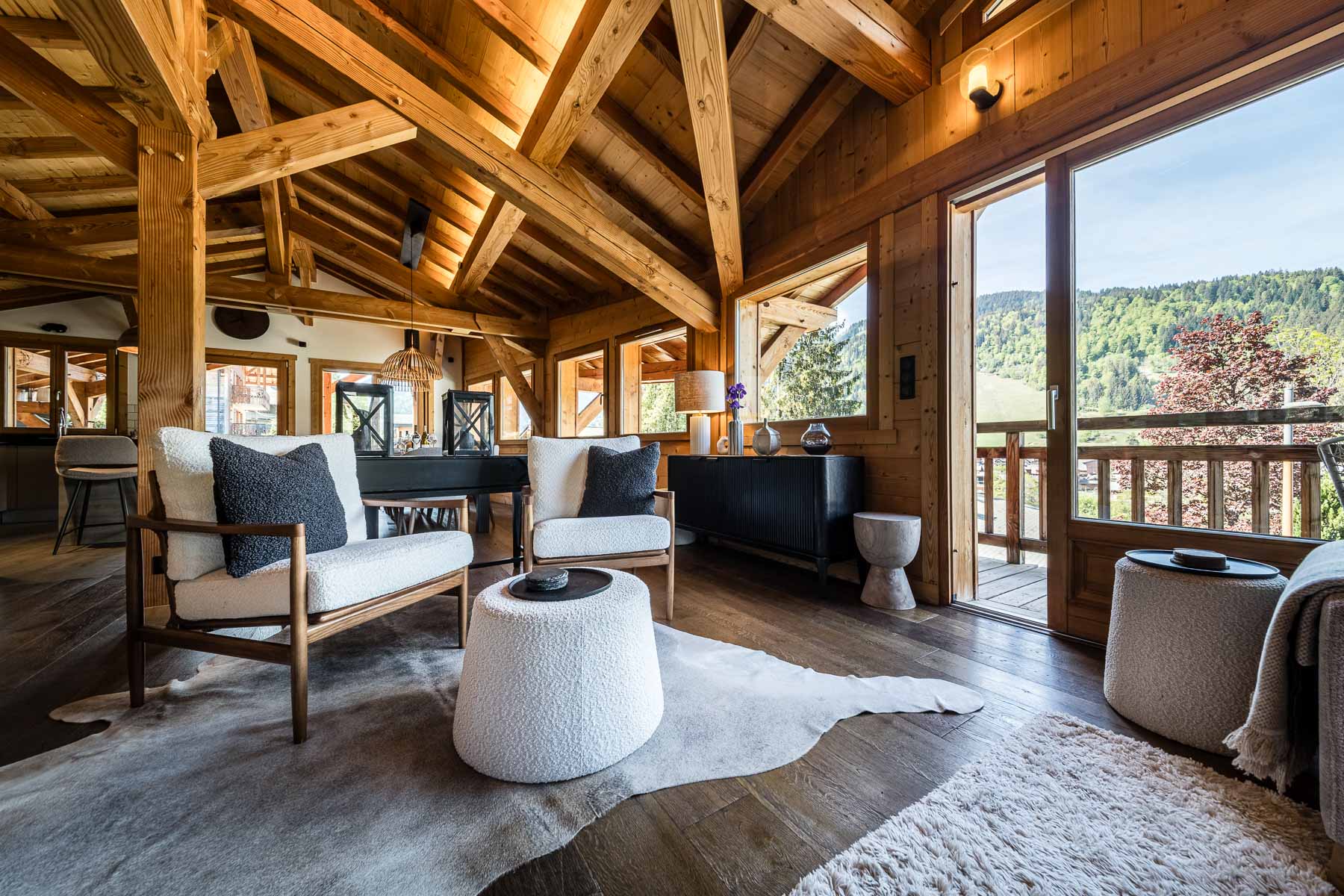 Open-plan lounge with mountain views at Chalet Floralies