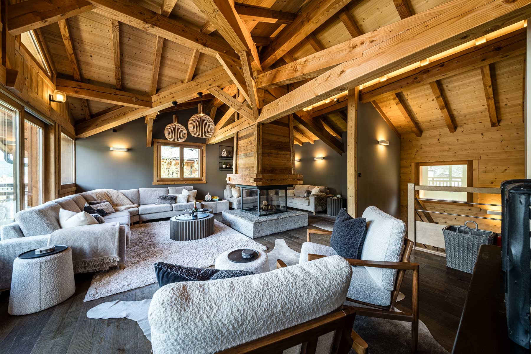 Spacious lounge with exposed timber beams at Chalet Floralies
