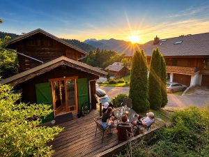 Garden terrace with sunset mountain views at Chalet Greniette