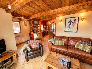 Open-plan lounge and kitchen at Chalet Greniette