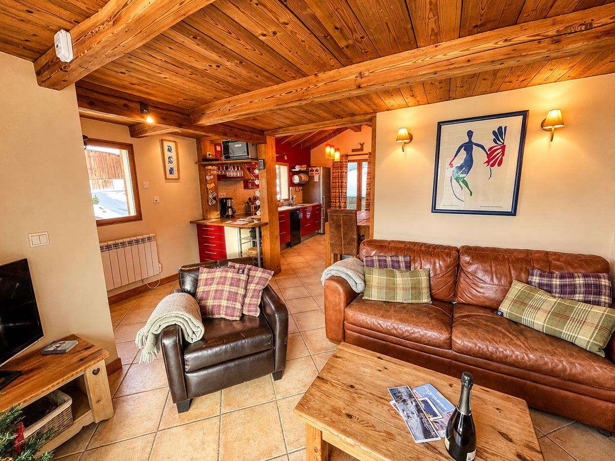Open-plan lounge and kitchen at Chalet Greniette