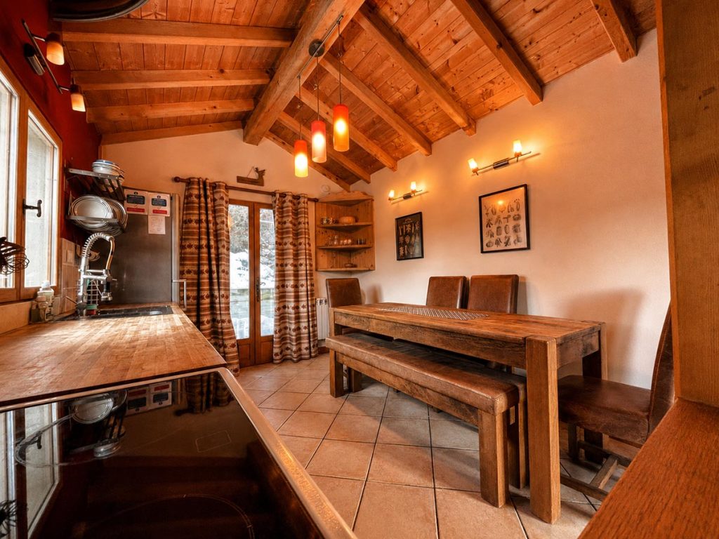Rustic kitchen and dining area at Chalet Greniette