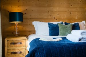 Open book on a bed at Chalet La Grange
