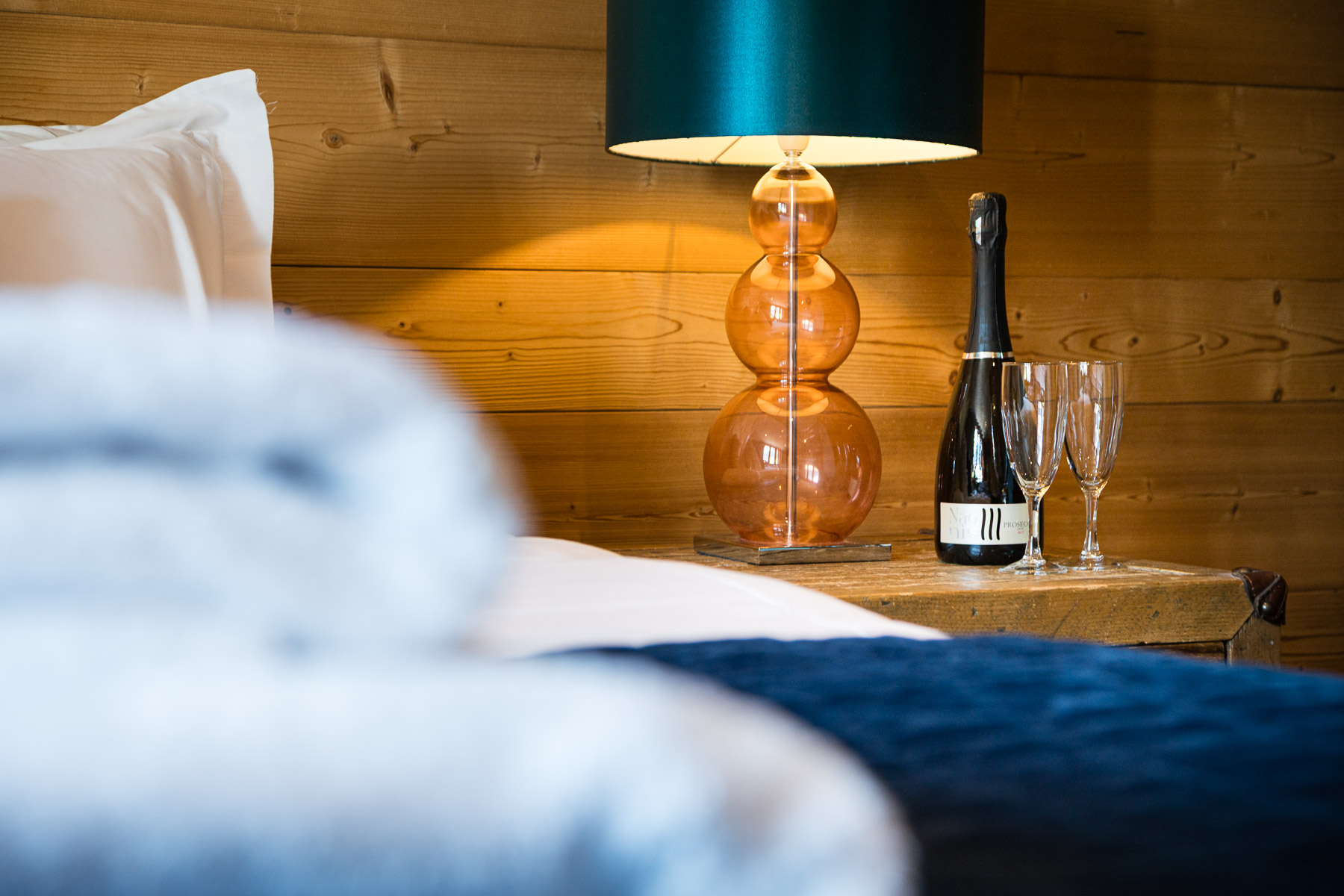 Prosecco beside a bed at Chalet La Grange