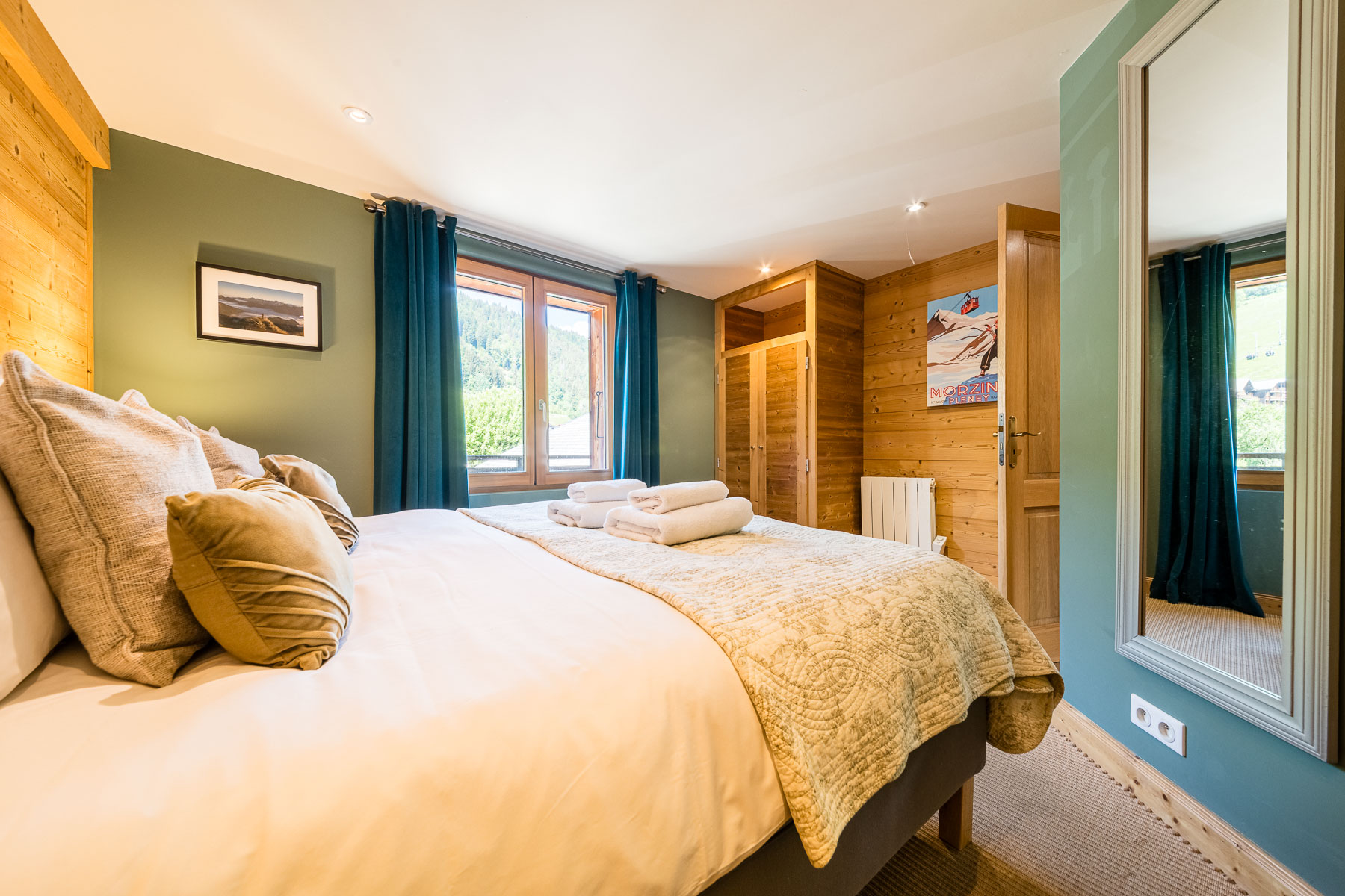 Double bedroom with alpine artwork at Chalet La Grange