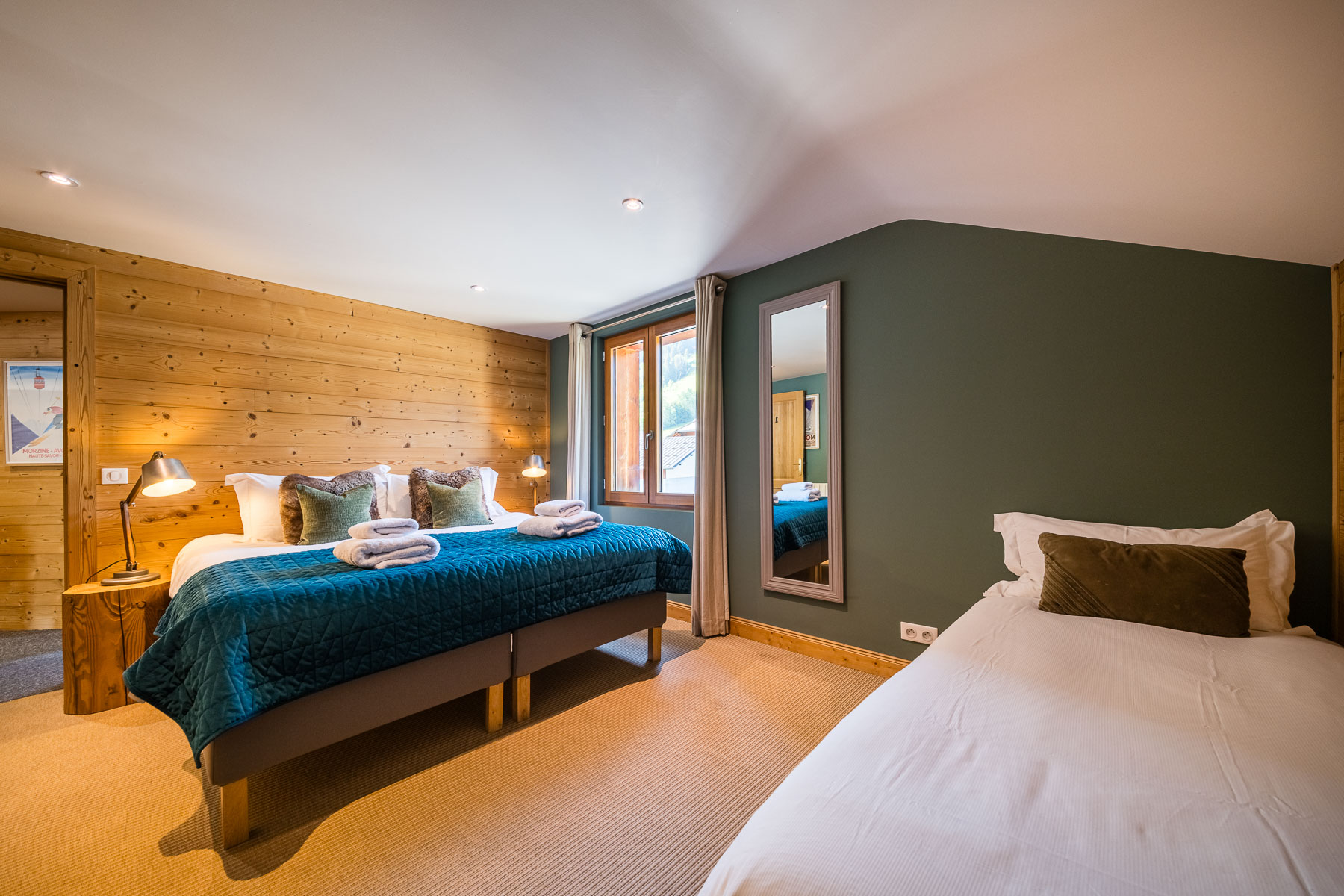 Family bedroom with double and single beds at Chalet La Grange