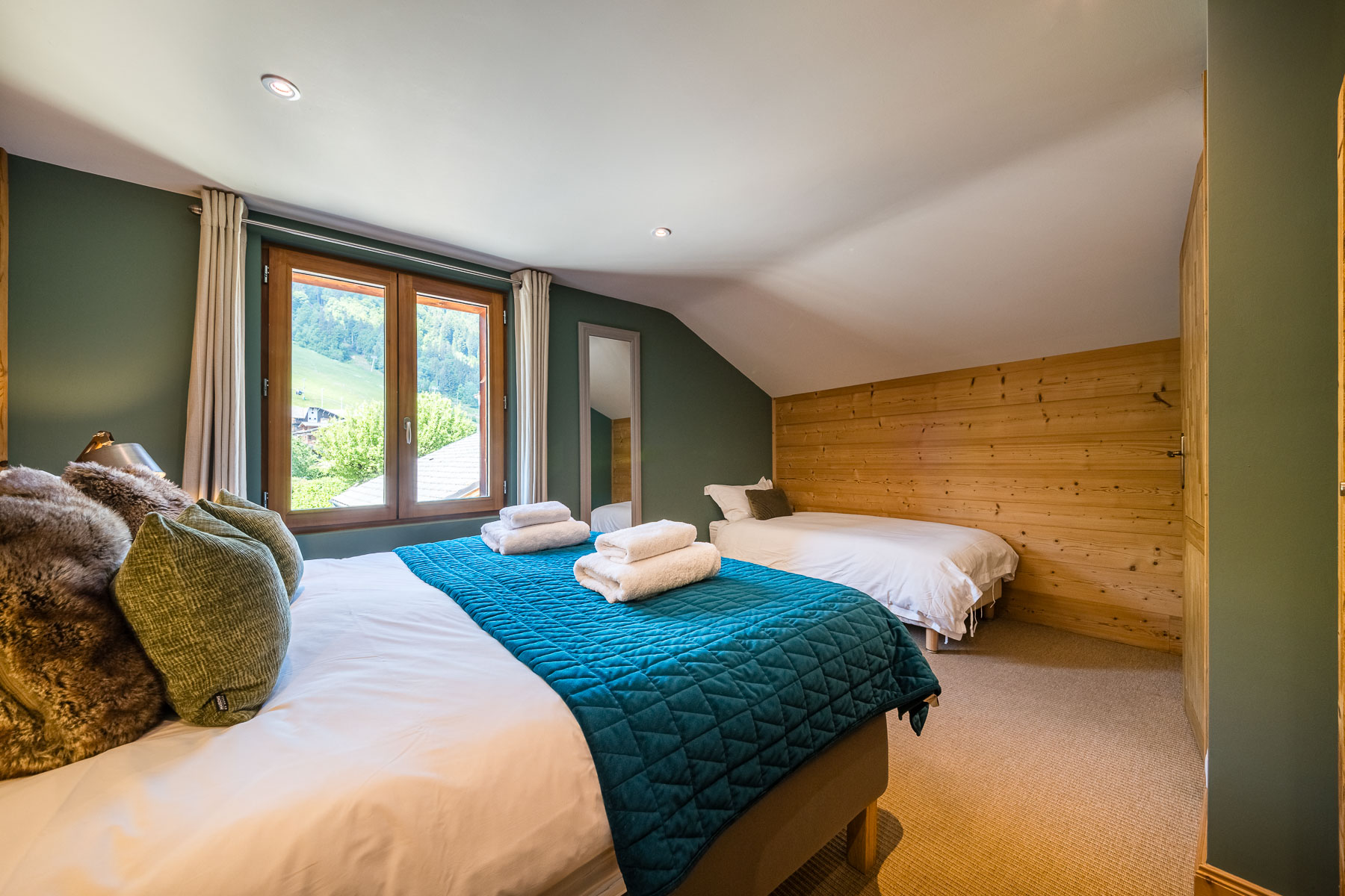 Family bedroom with mountain views at Chalet La Grange