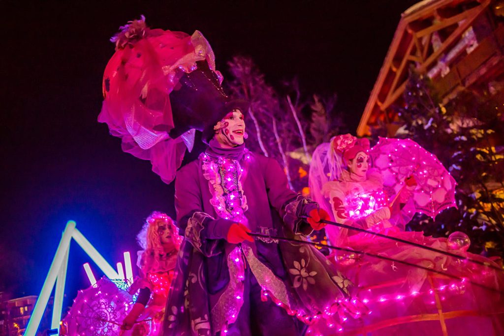 christmas parade in morzine showing people dressed up and dancing