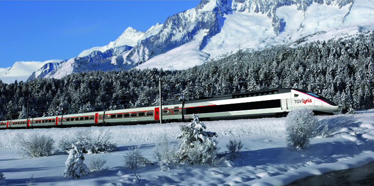 Train travelling through the snowy Alps towards Morzine